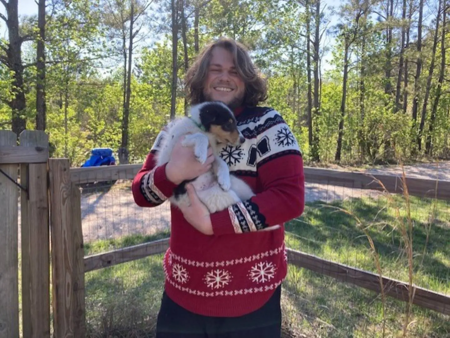 A woman holding a dog in her arms.