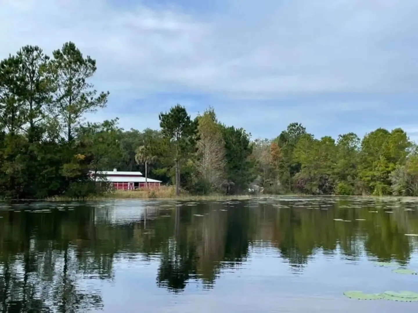 A house sitting on the edge of a lake.